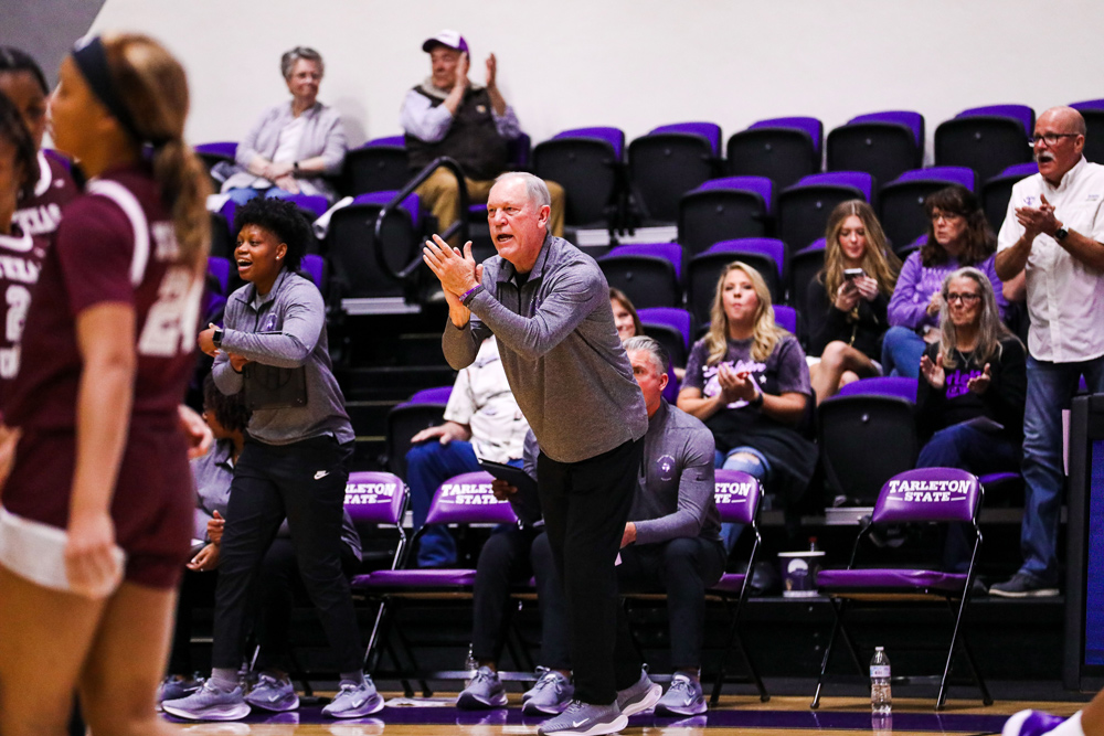 Coach clapping at team on sidelines